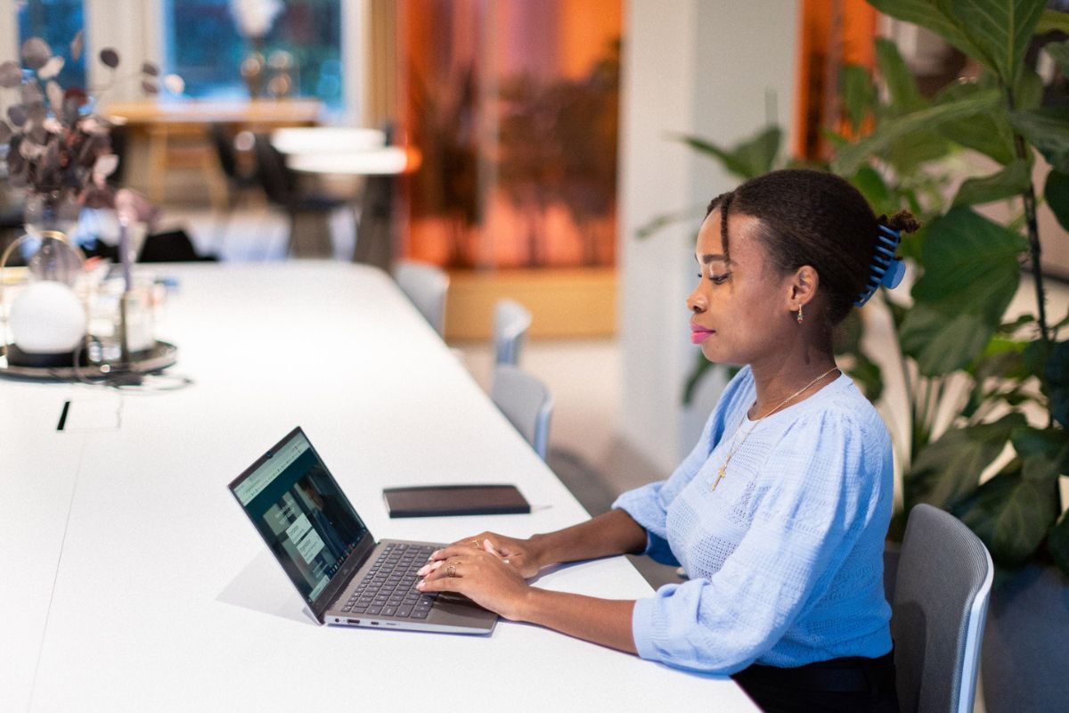 Woman sitting in front of a computer reading about background checks