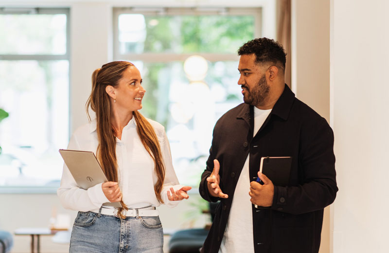 two DISA colleagues having a dicussion in the hall way