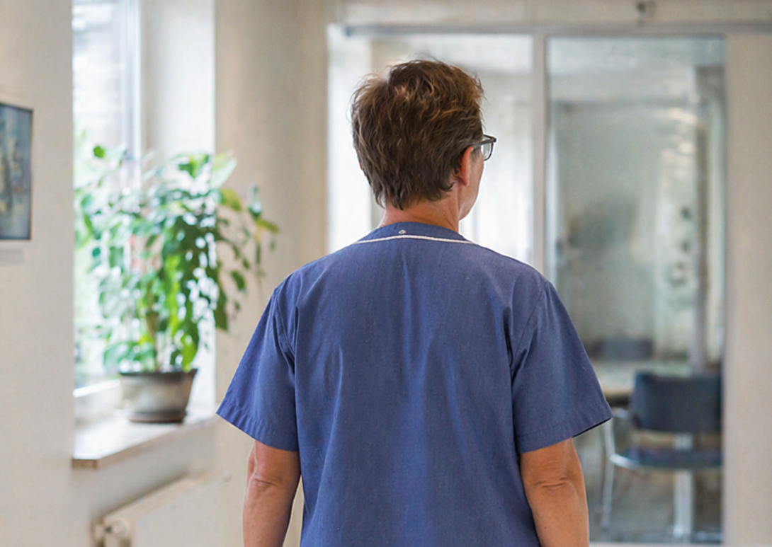 Old female doctor walking in a corridor