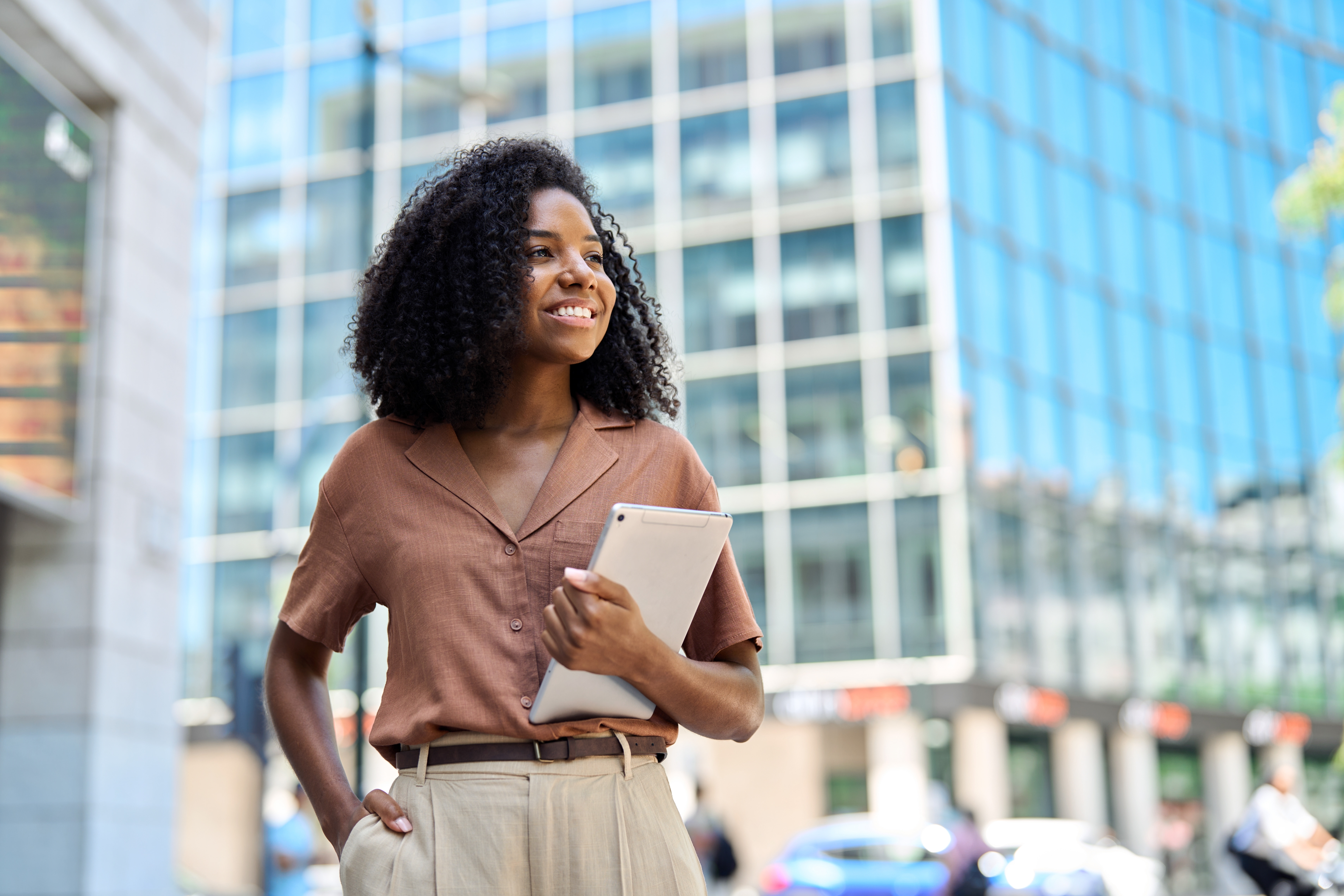 Woman in a city enviroment carrying her tablet