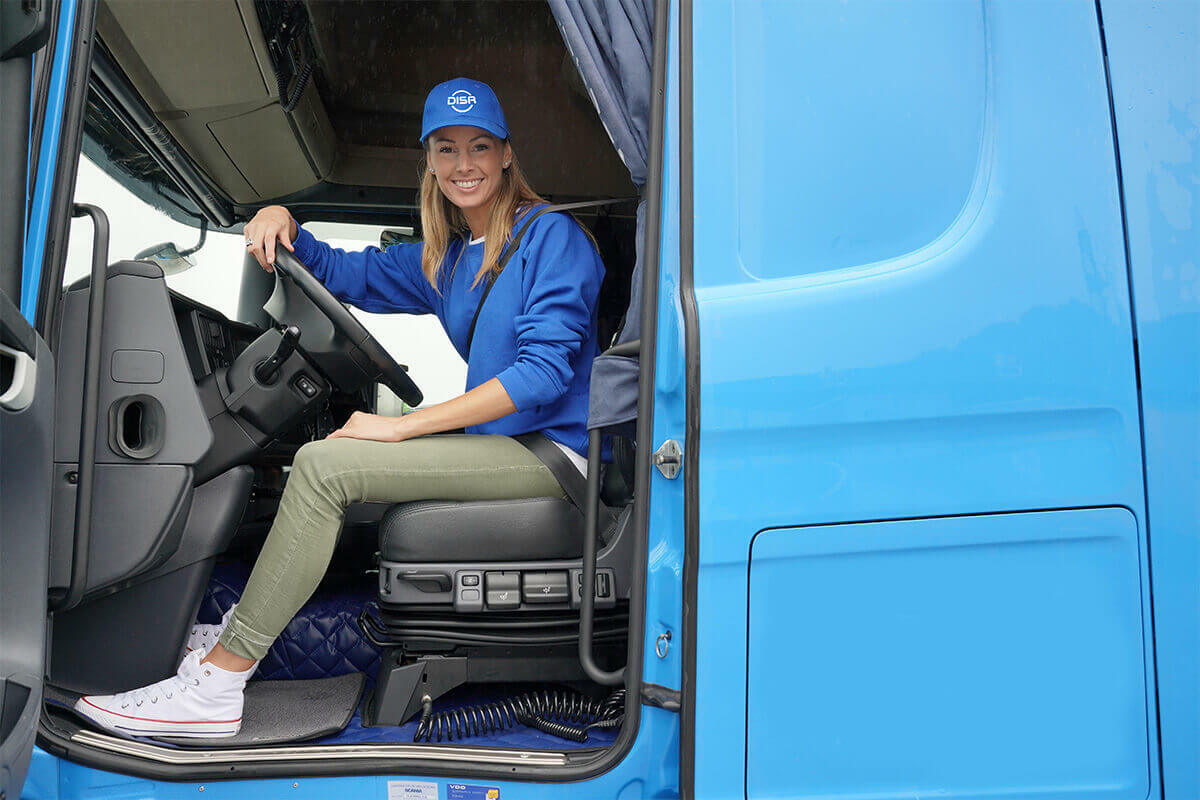 Female truck driver sitting in an 18-wheeler