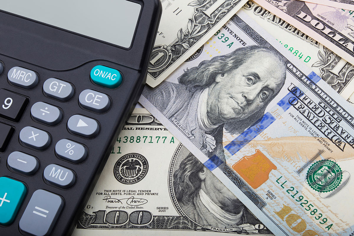 one-hundred-dollar bills and calculator