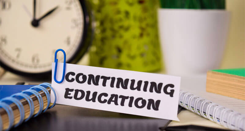 Continuing Education on piece of paper on a desk