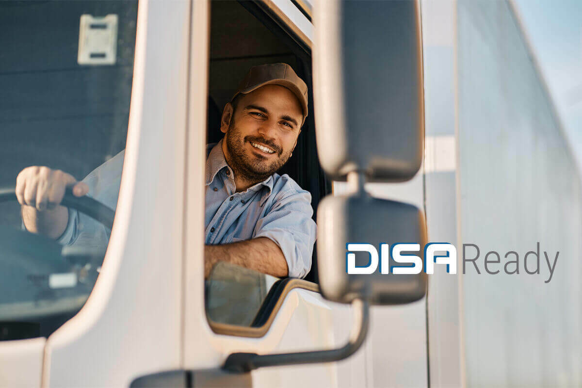 Truck driver leaning out the window smiling with DISAReady logo