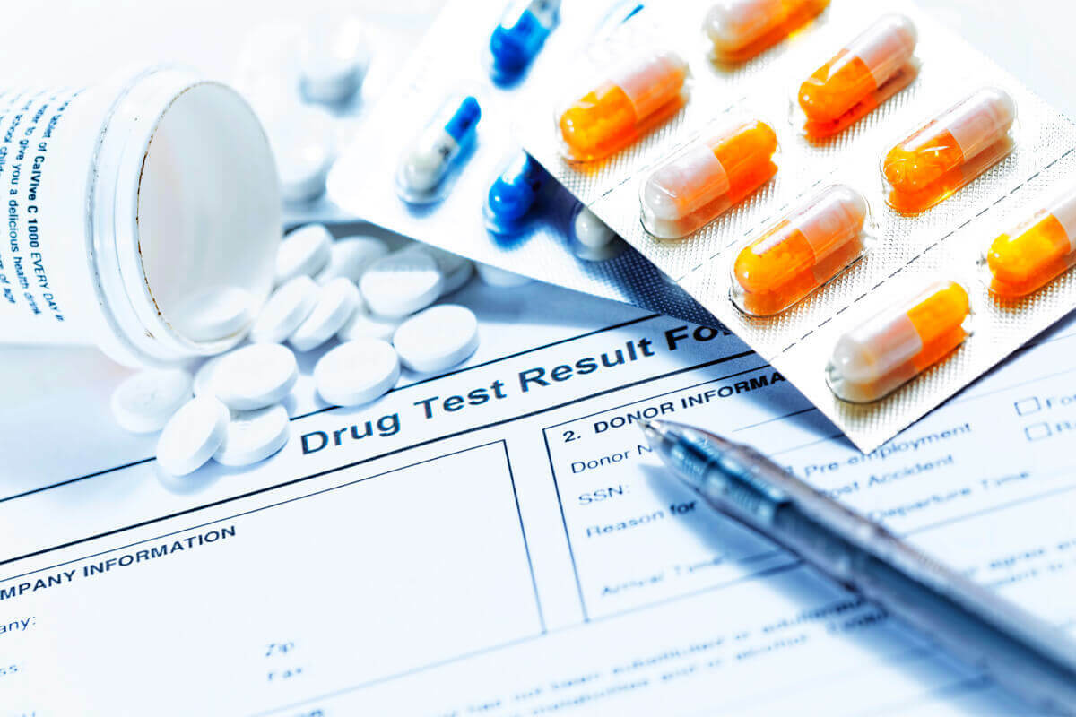 prescription drugs spilled onto a drug test result form