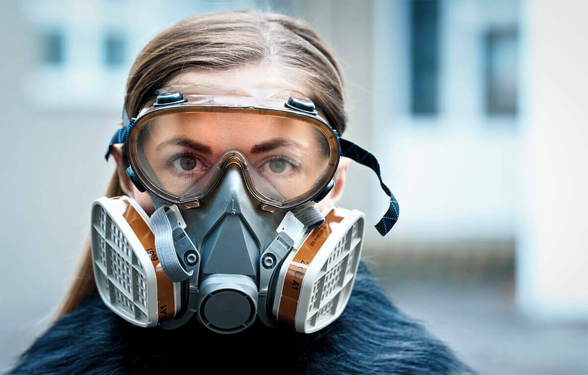 Worker practicing safety by wearing a respirator mask