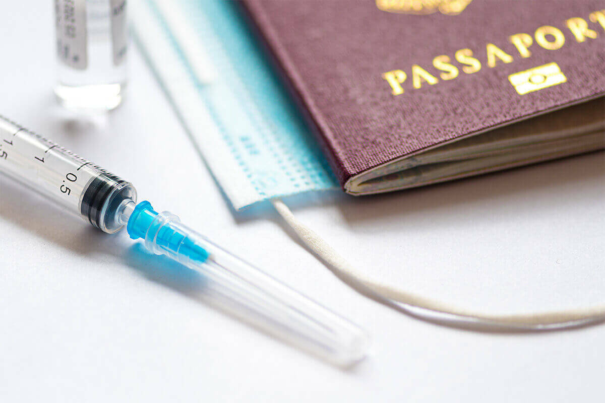 Passport and a vaccination sitting on a table