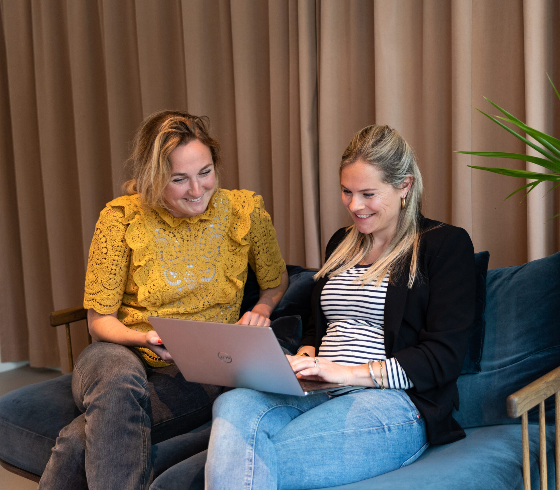 Two colleagues support the screening process on laptop