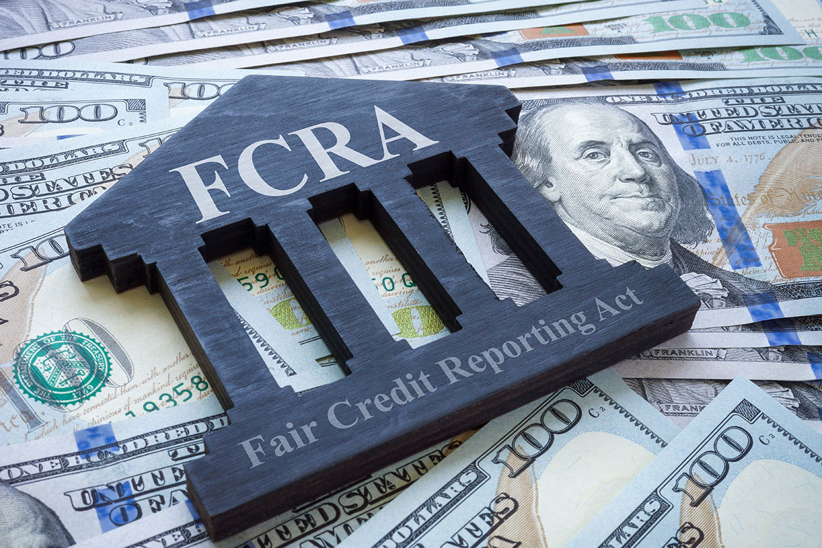Money and bank-shaped plate FCRA Fair credit reporting act.
