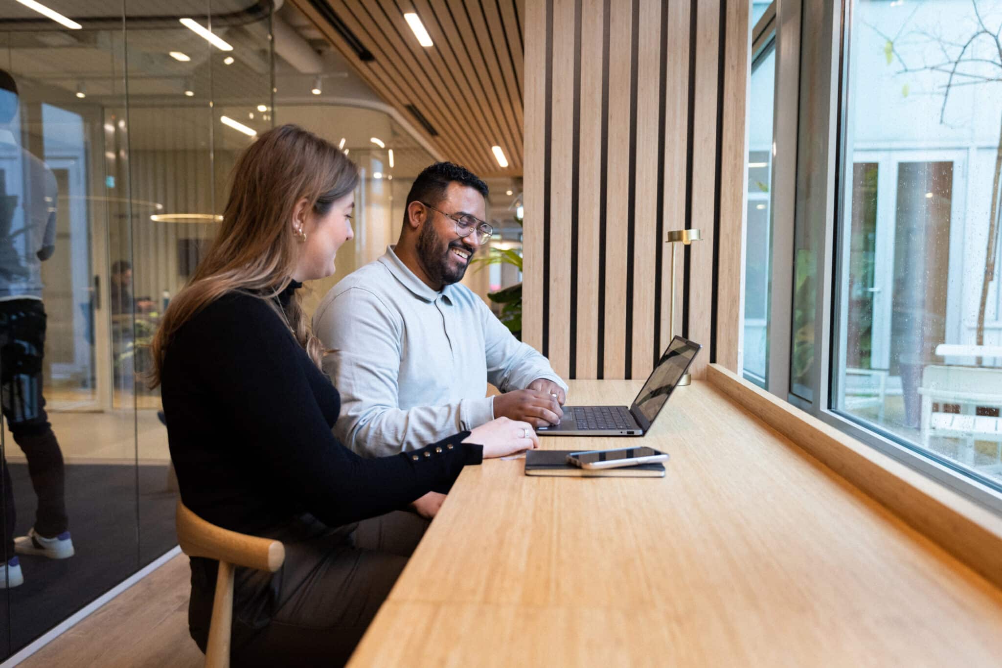 Two colleagues are reading about how background checks and GDPR work in relation to recruitment and employment
