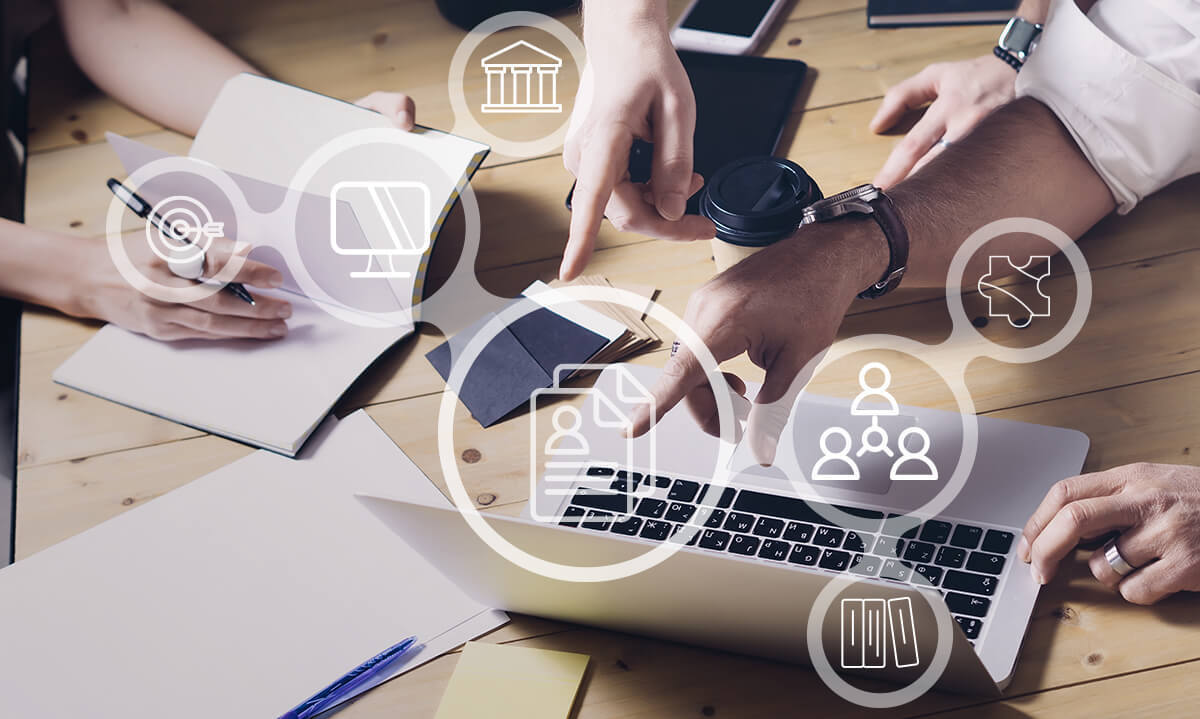 Group of people around a computer reviewing documents
