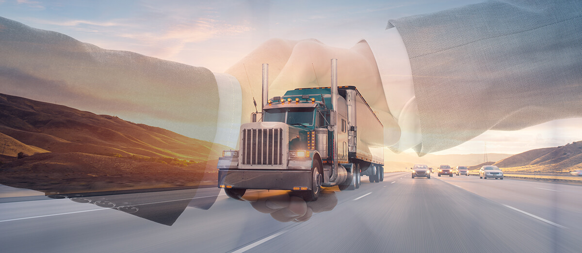 Handshake superimposed over an 18-wheel truck driving on the road
