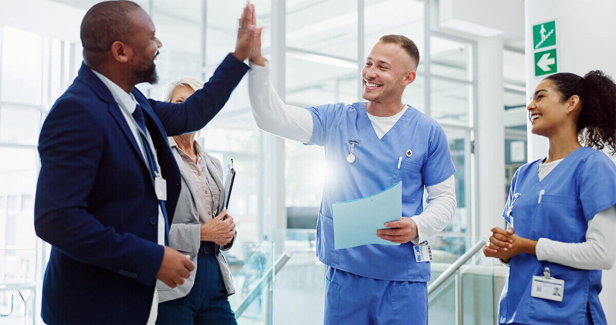 healthcare staff high fiving celebrating at hospital