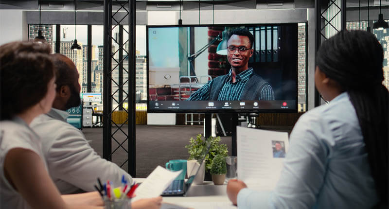 Recruiters conducting an online video interview with a candidate to evaluate employment history