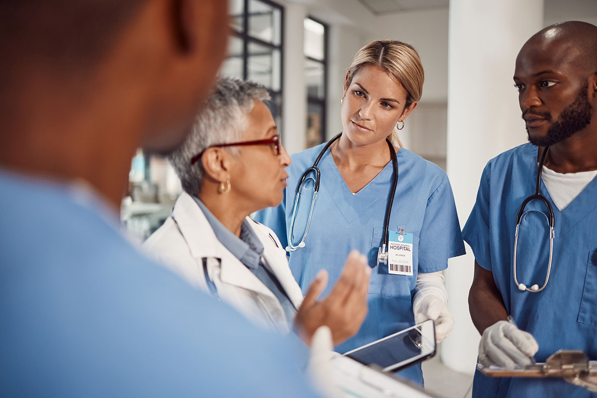 Nurses in hospital listening to doctor