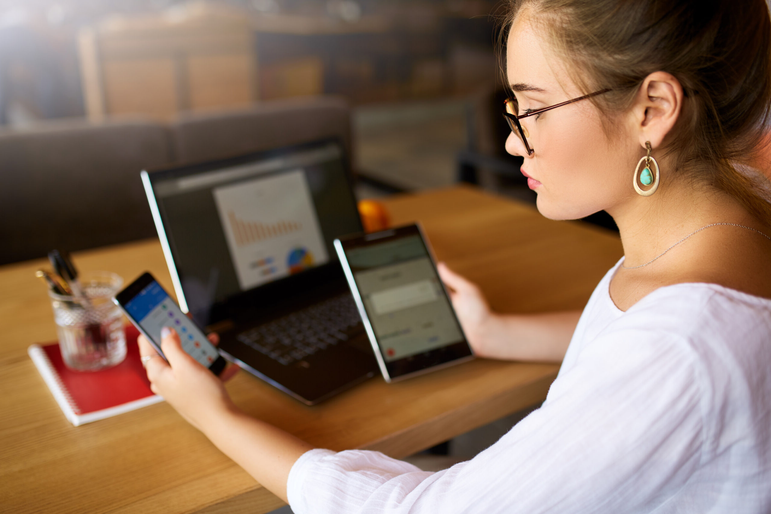 woman viewing website on laptop, tablet, and phone