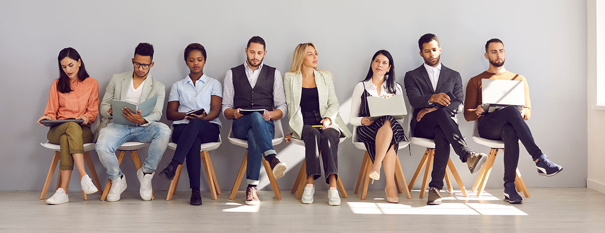job applicants sitting in a row waiting for interview