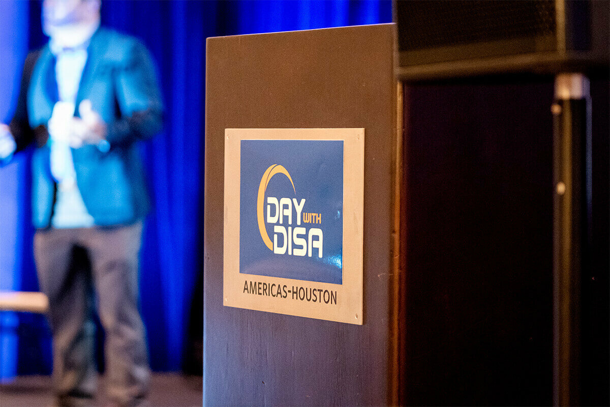 Day with DISA logo on a podium with speaker in the background