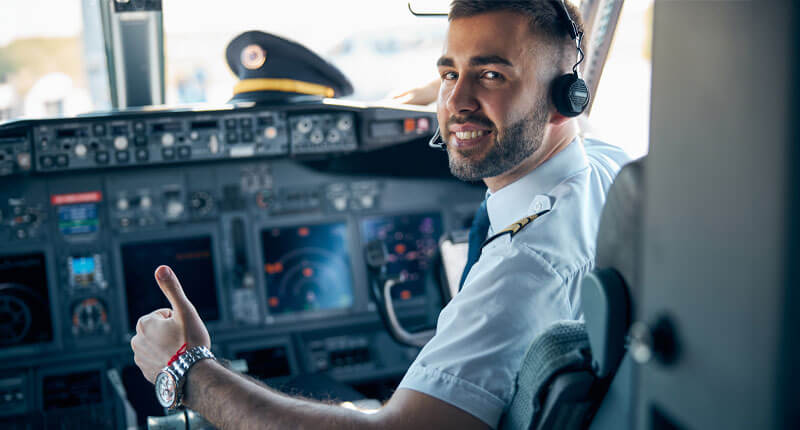 male posing at the camera in cabin of passenger aircraft