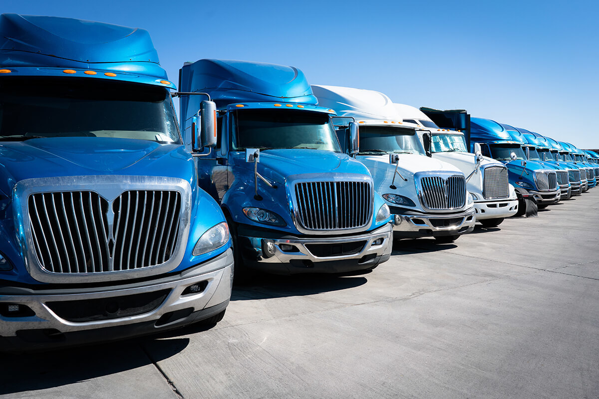 Trucking fleet lined up in a parking lot