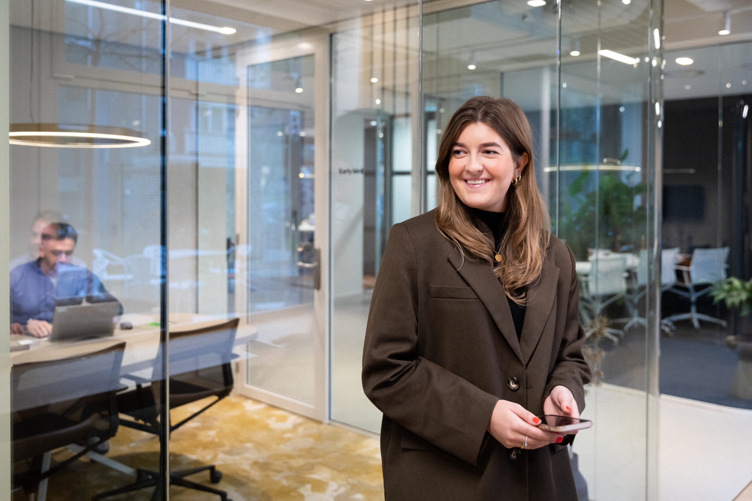 Female employer standing in an office.