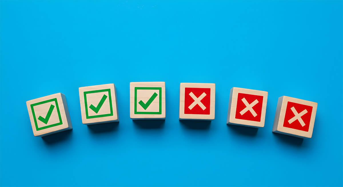 3 wooden blocks with green check marks and 3 wooden blocks with red x marks on a blue background