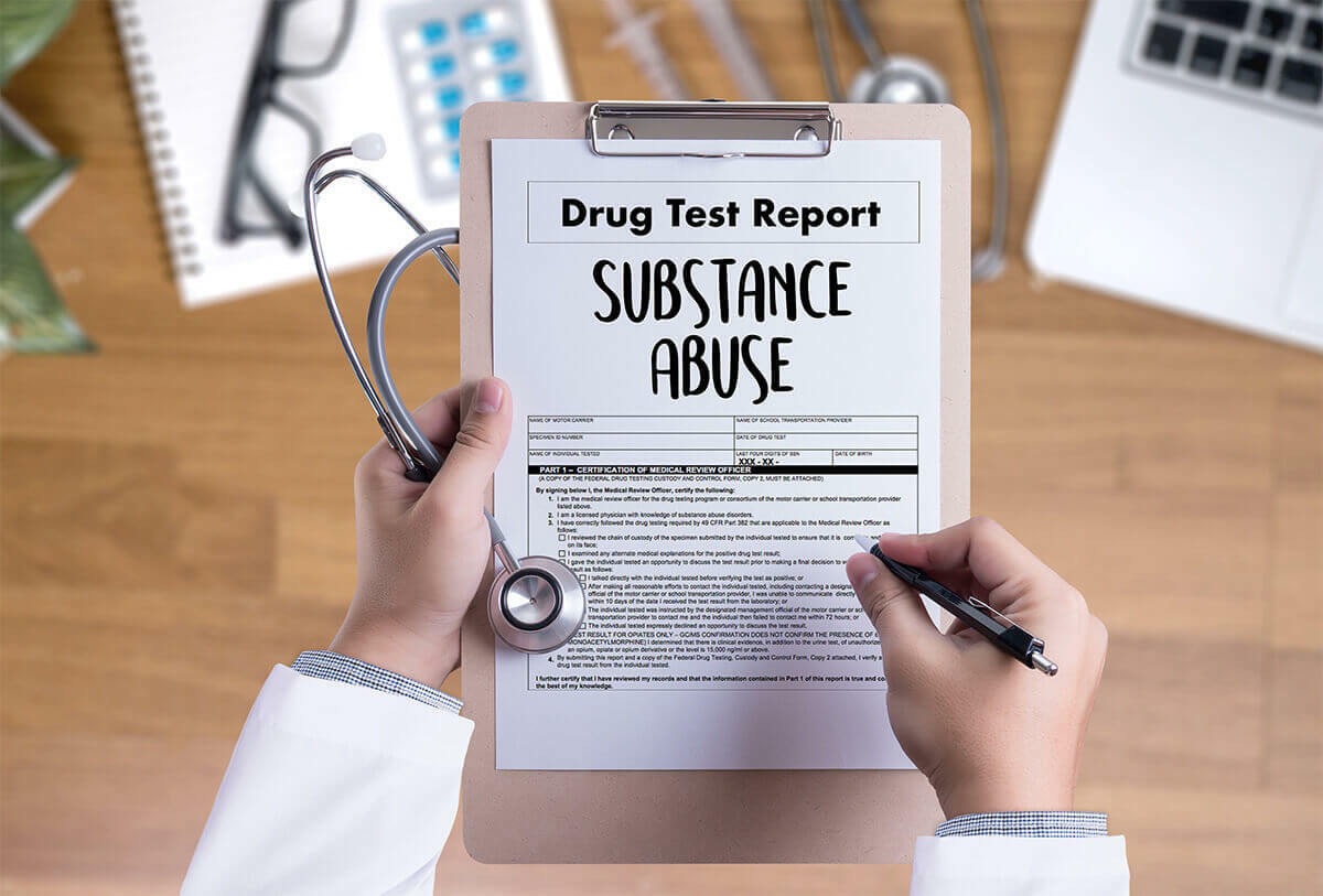 doctor holding a clipboard with a Substance Abuse Report form