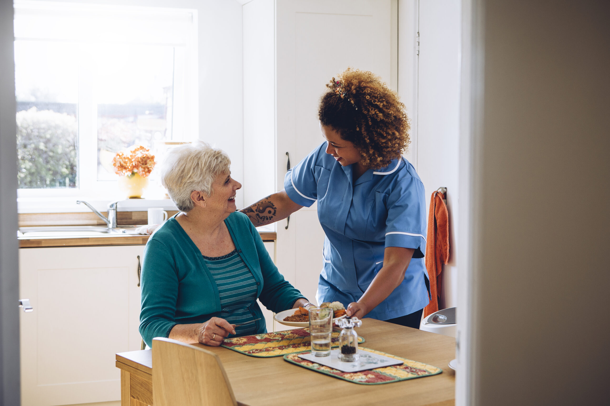 healthcare employee serving lunch to a patient