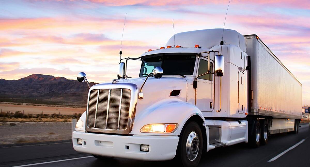 truck driving in sunset