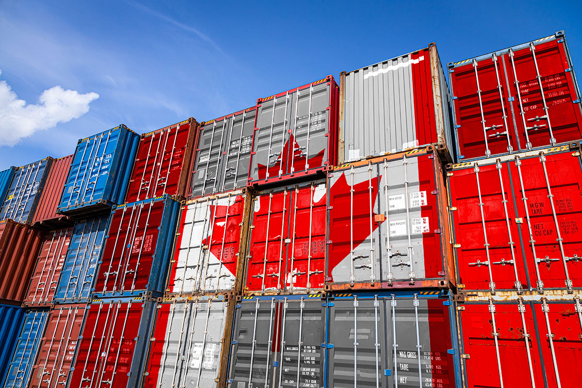 The national flag of Canada on a large number of metal containers for storing goods stacked in rows on top of each other. Conception of storage of goods by importers, exporters