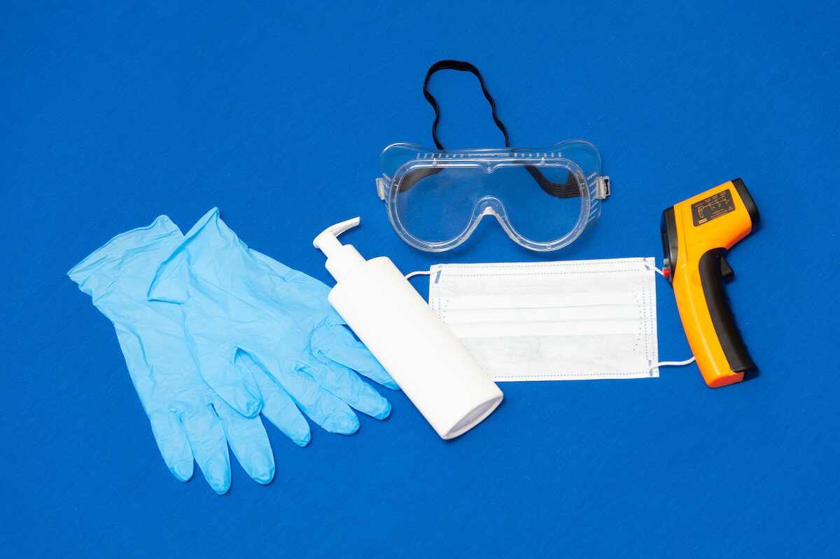 latex gloves, sanitizer, goggles, mask, and thermometer