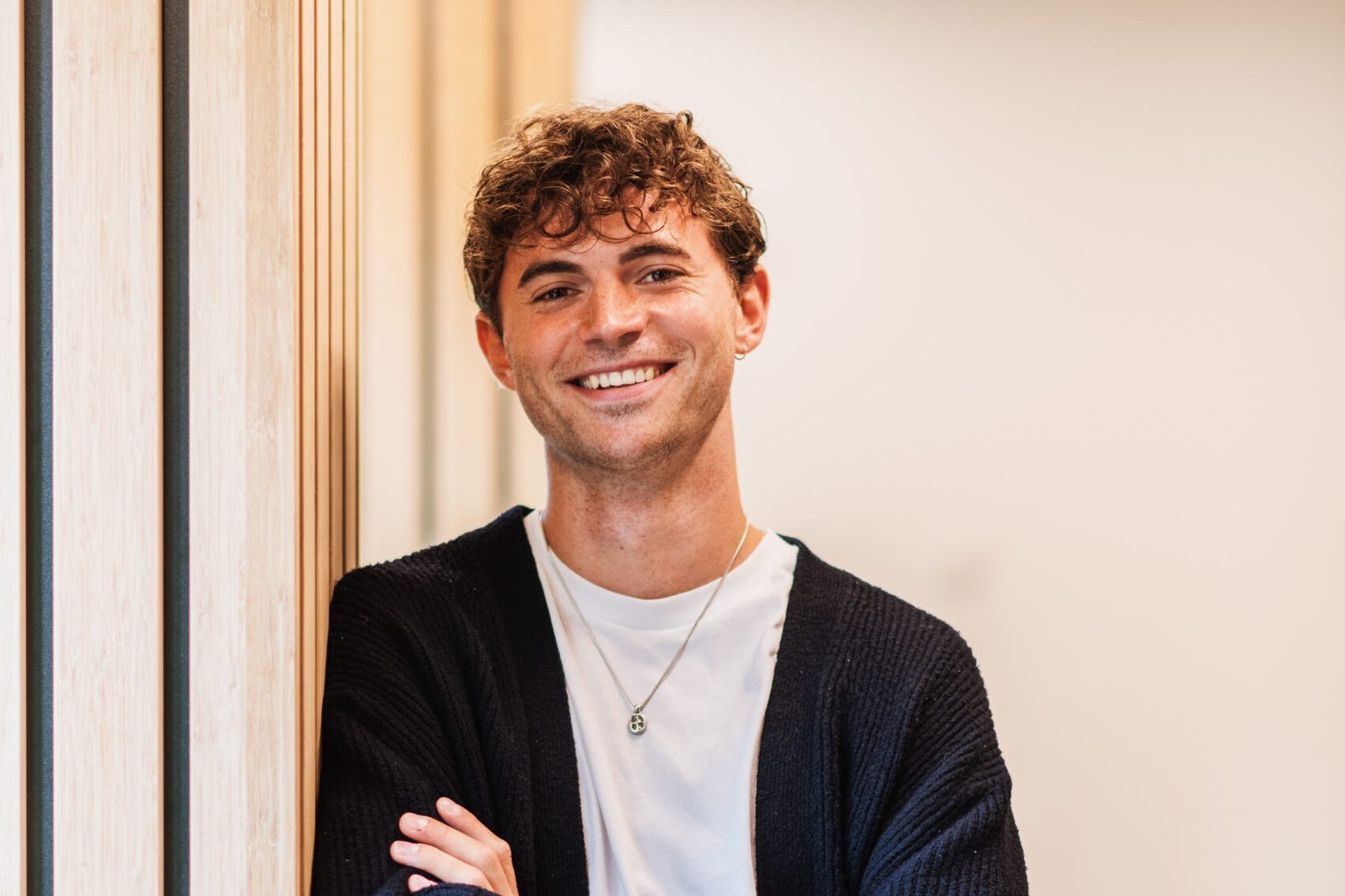 A smiling employee stands by the corridor at the DISA office in Amsterdam