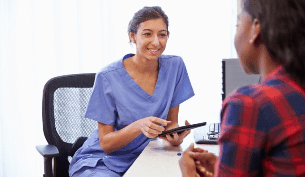Healthcare worker collecting patient data on a tablet