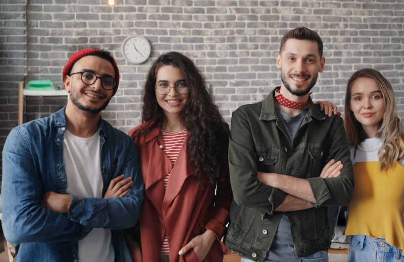 group of young IT professionals standing with arms crossed