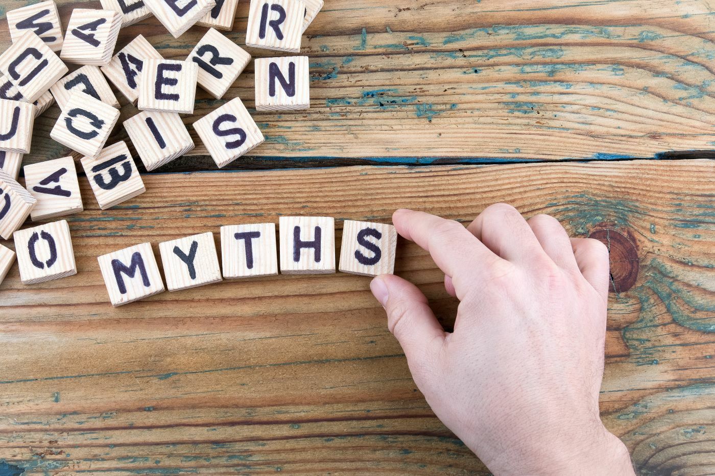 Scrabble game letters spelling out the word "myths"