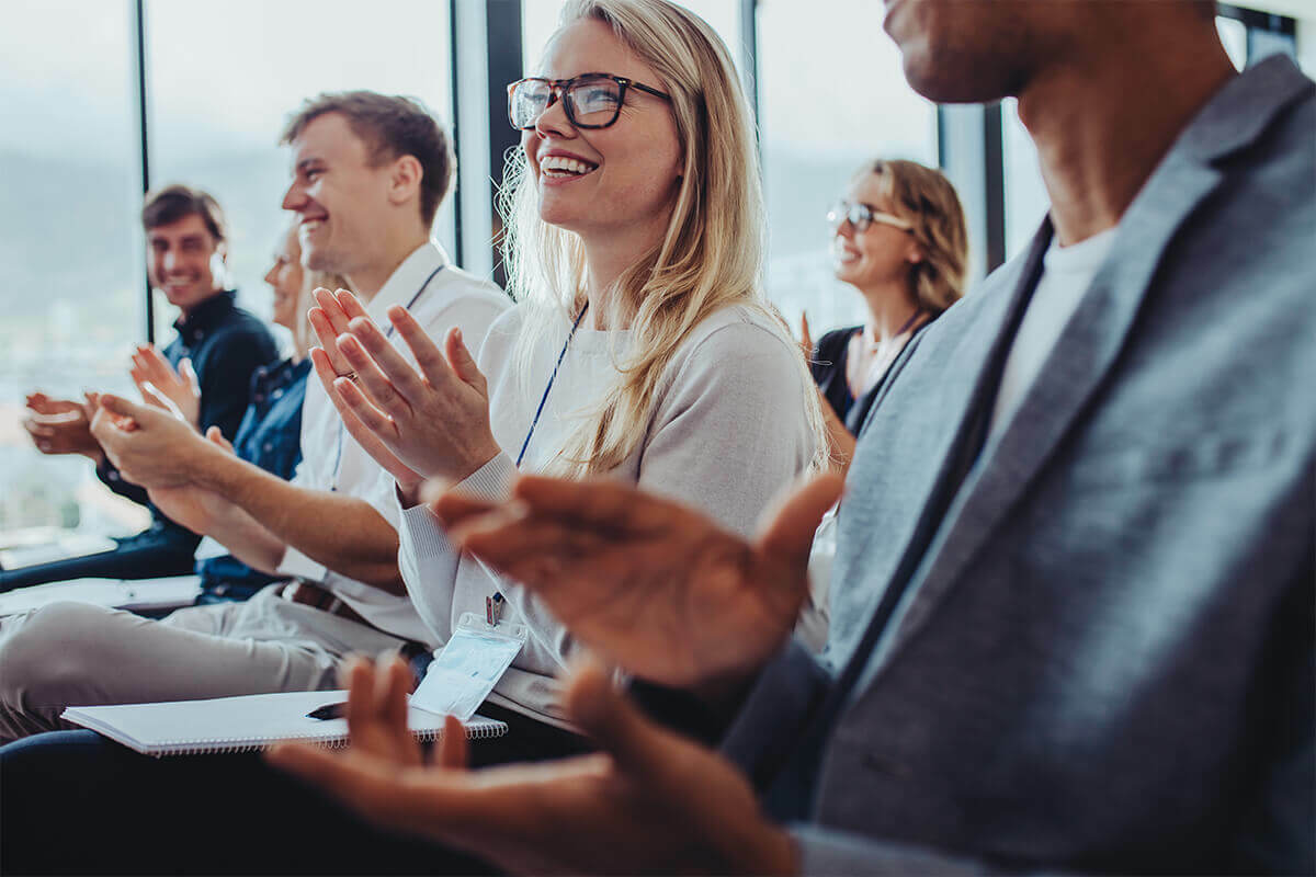 audience clapping at a conference