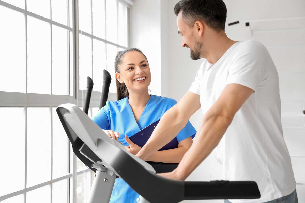 nurse administering a physical fitness exam to a worker on a treadmill