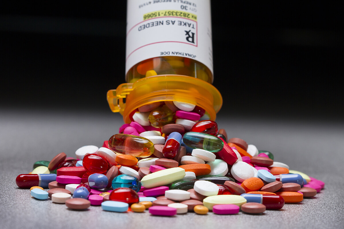 opioids spilling from prescription bottle