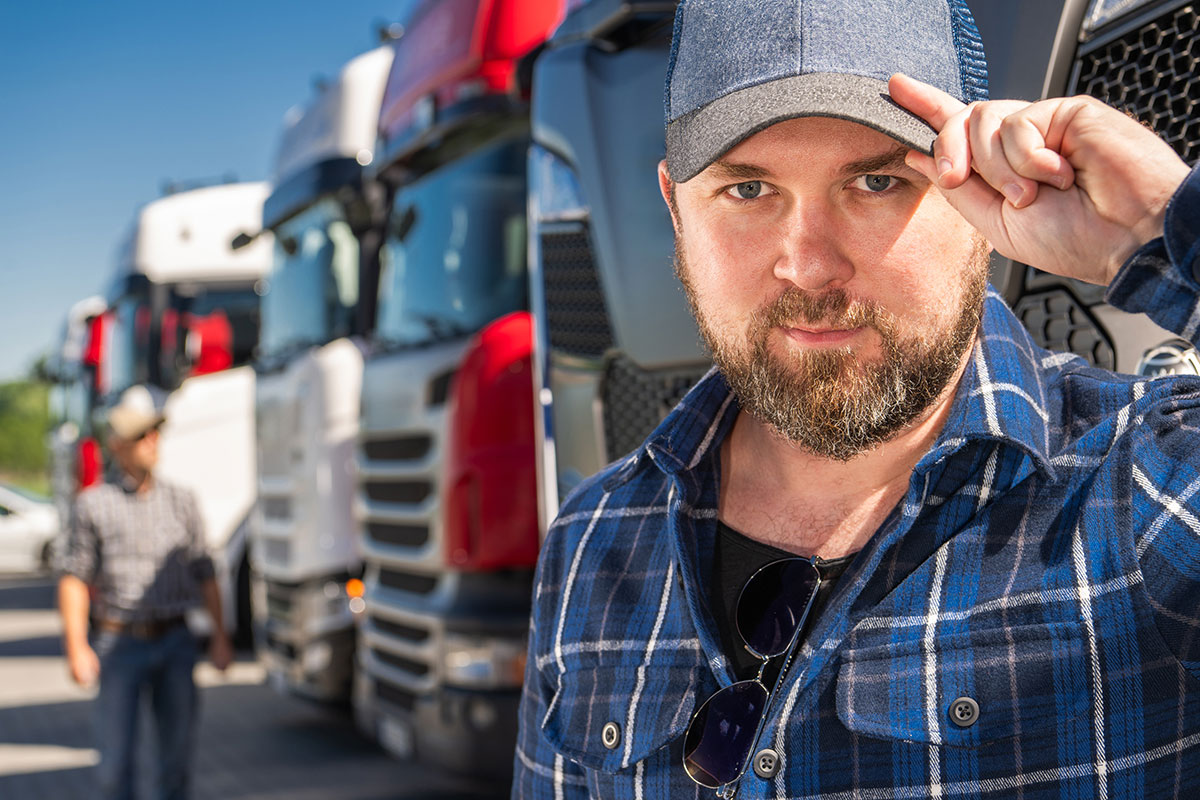 DOT employee standing in front of several trucks saying goodbye