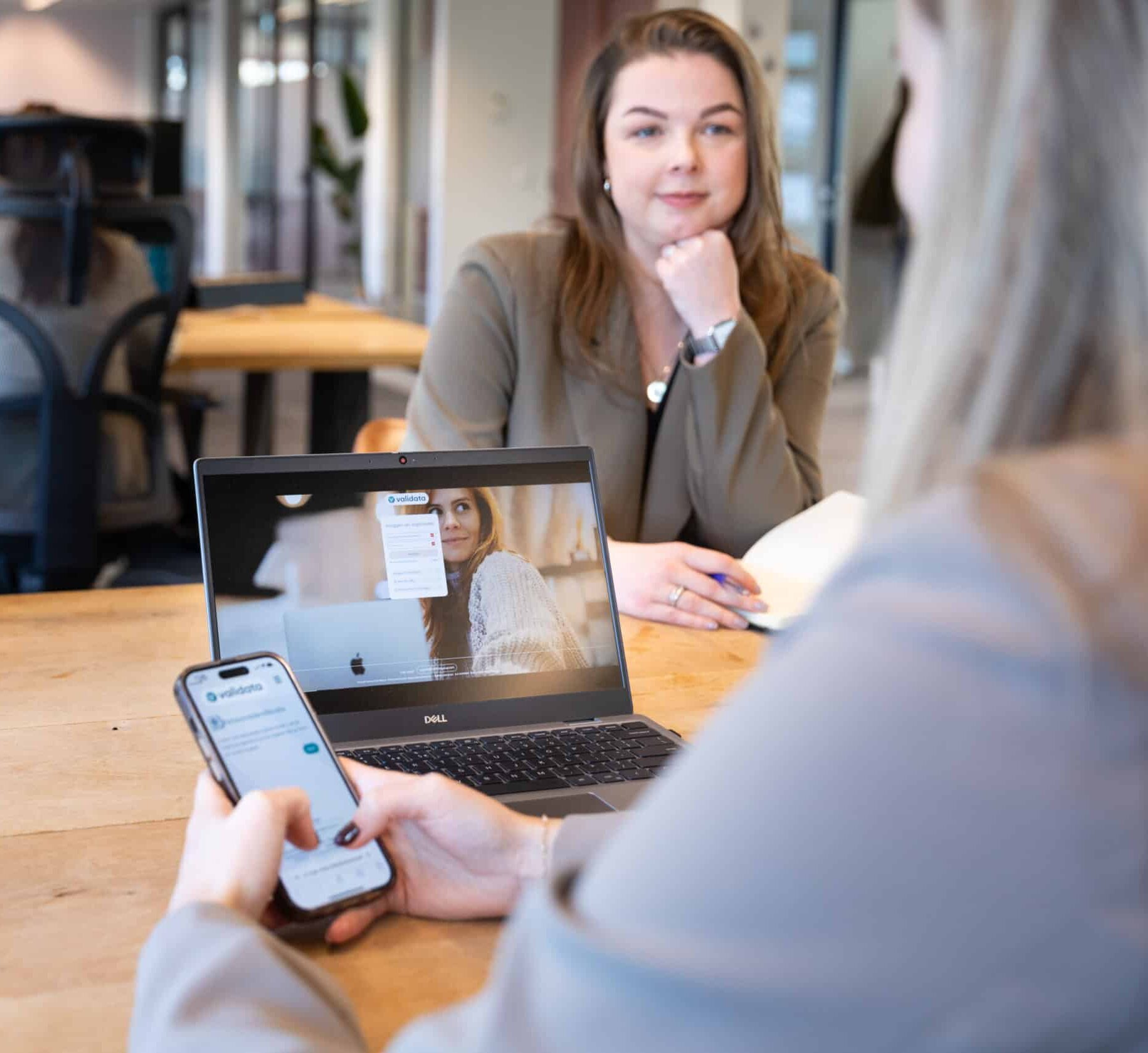 Two female colleagues meet to discuss how the procurement of background checks works for municipalities.