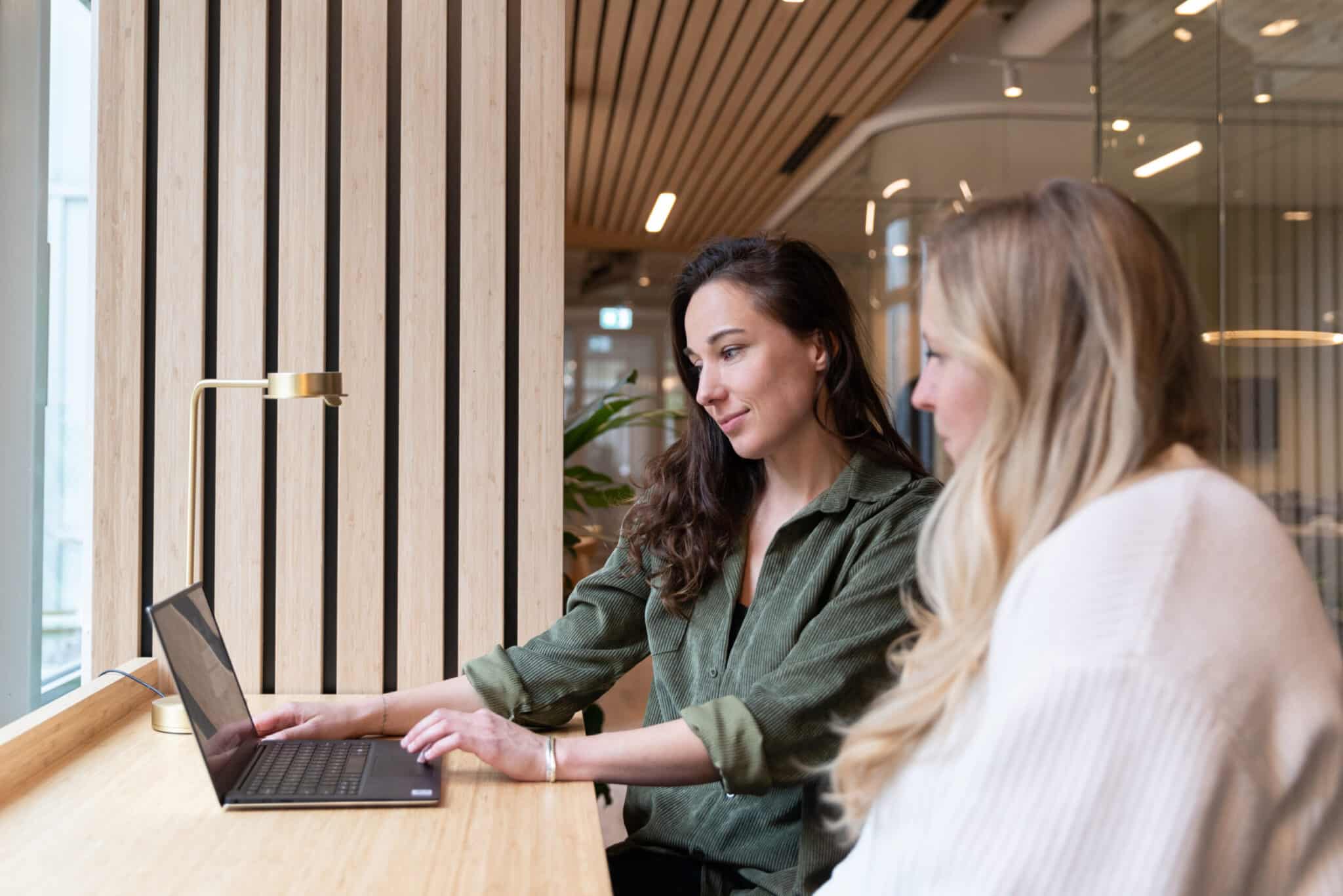 two women working on applicant screening in office