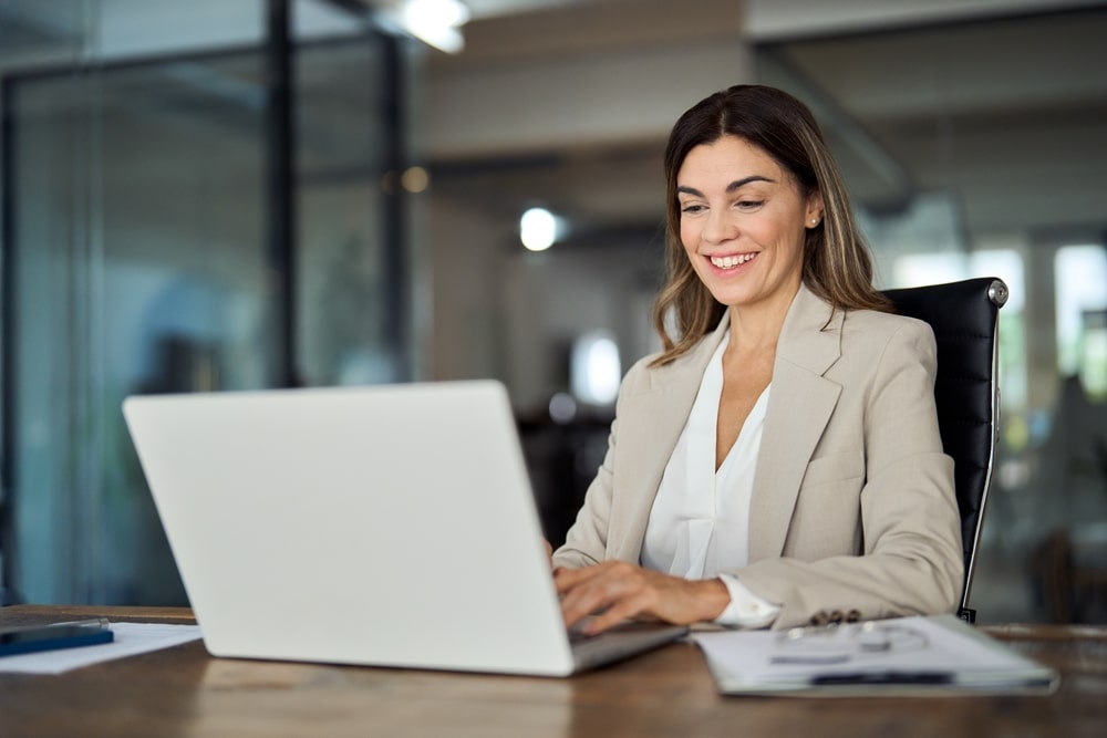 Woman sitting at a computer in an office environment
