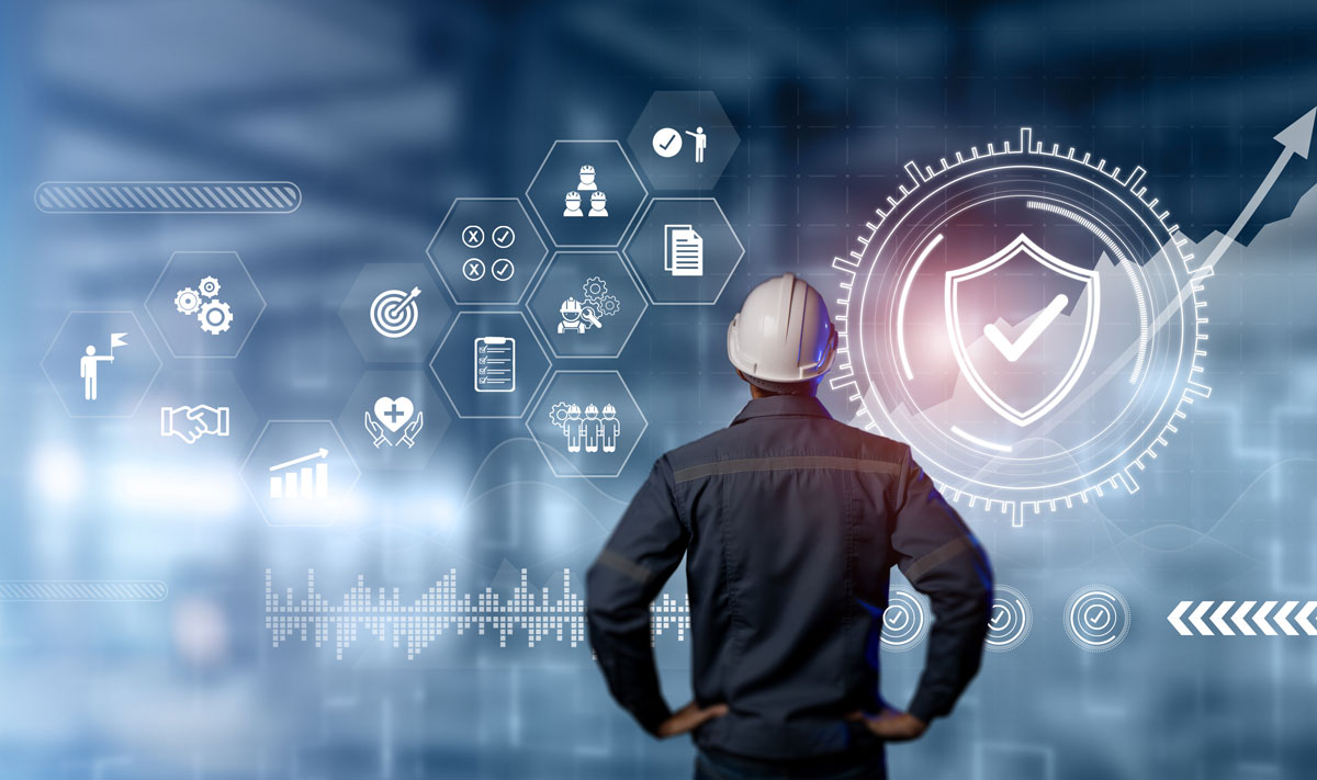 man wearing a hard hat looking at icons regarding workplace safety