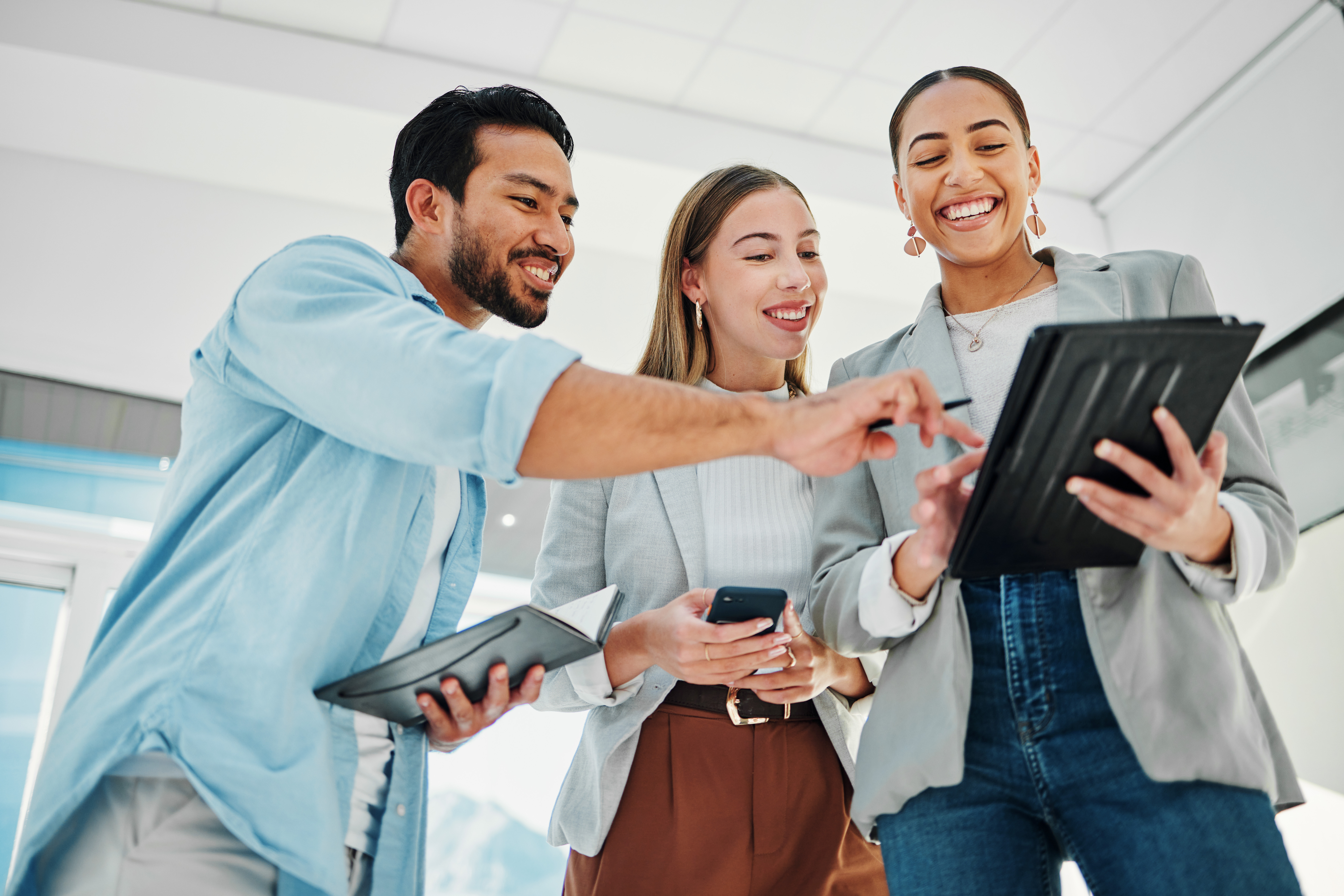 Three professionals looking at tablet