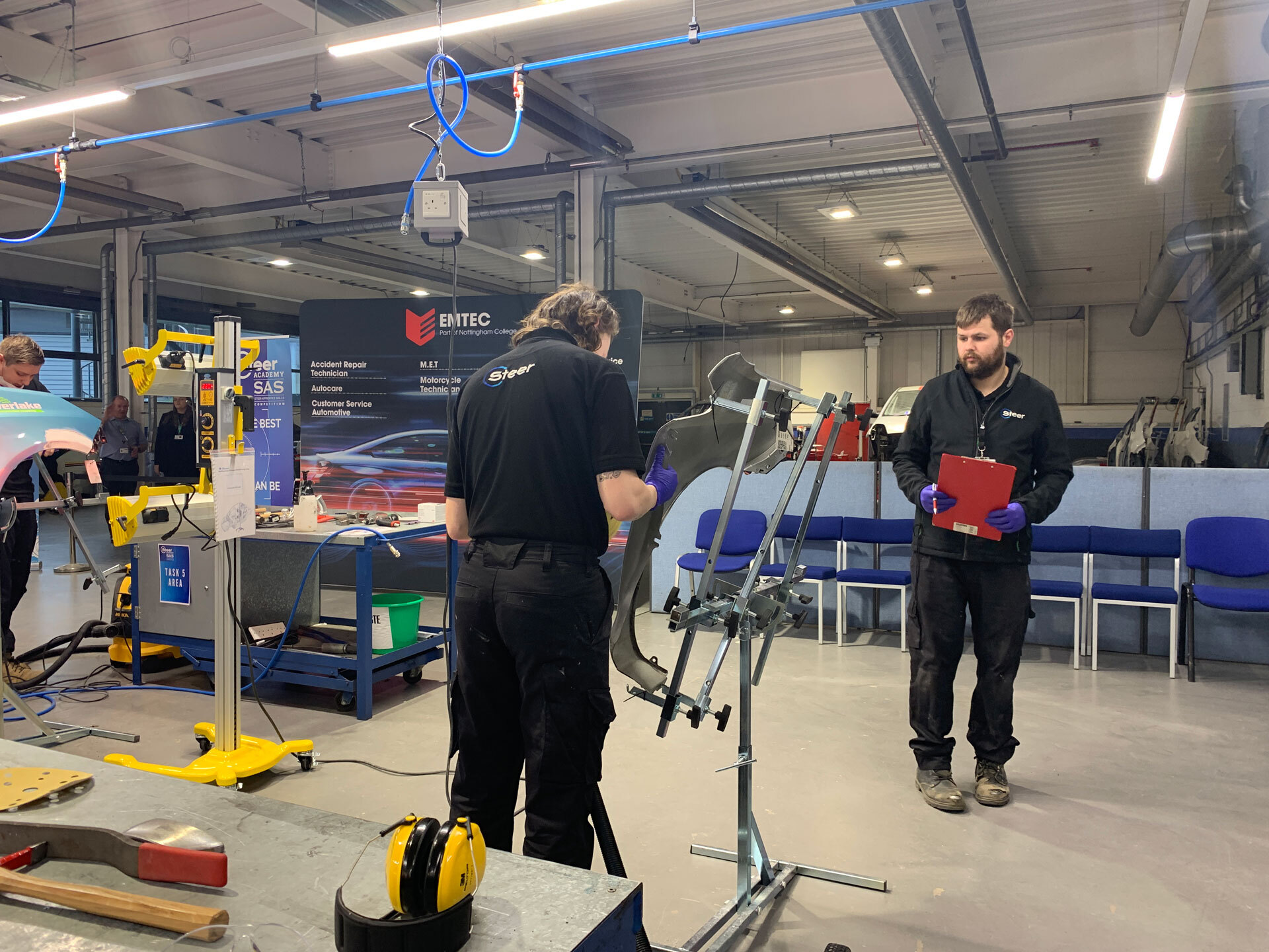 Two apprentices working in an Emtec workshop.