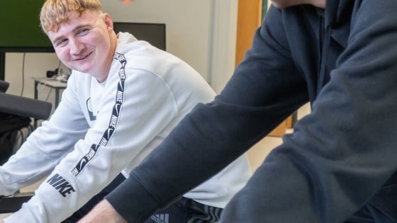 Two students using exercise bikes