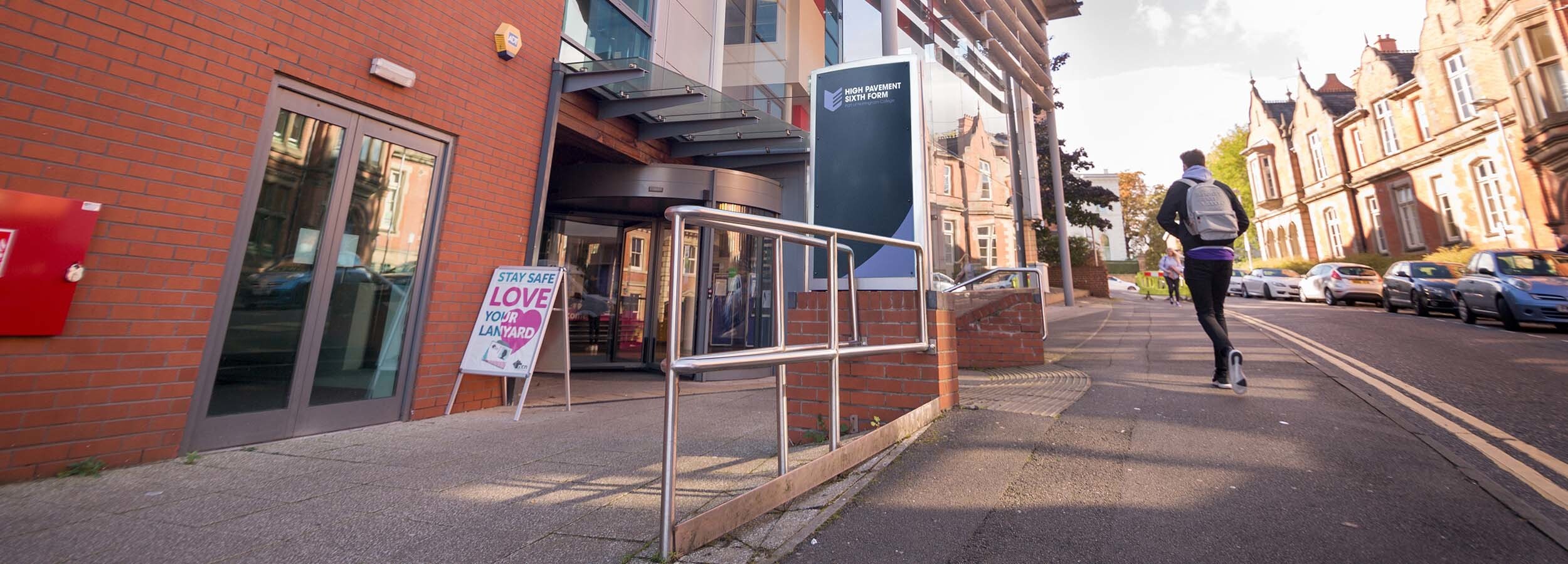 Resources and Facilities Alt Text Front entrance of High Pavement with a person walking past