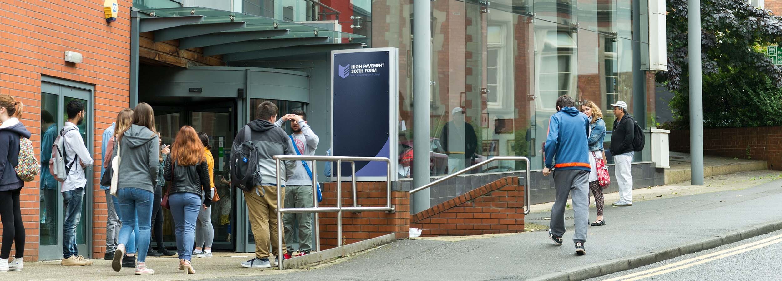 Students standing outside and walking into High Pavement Sixth Form Centre