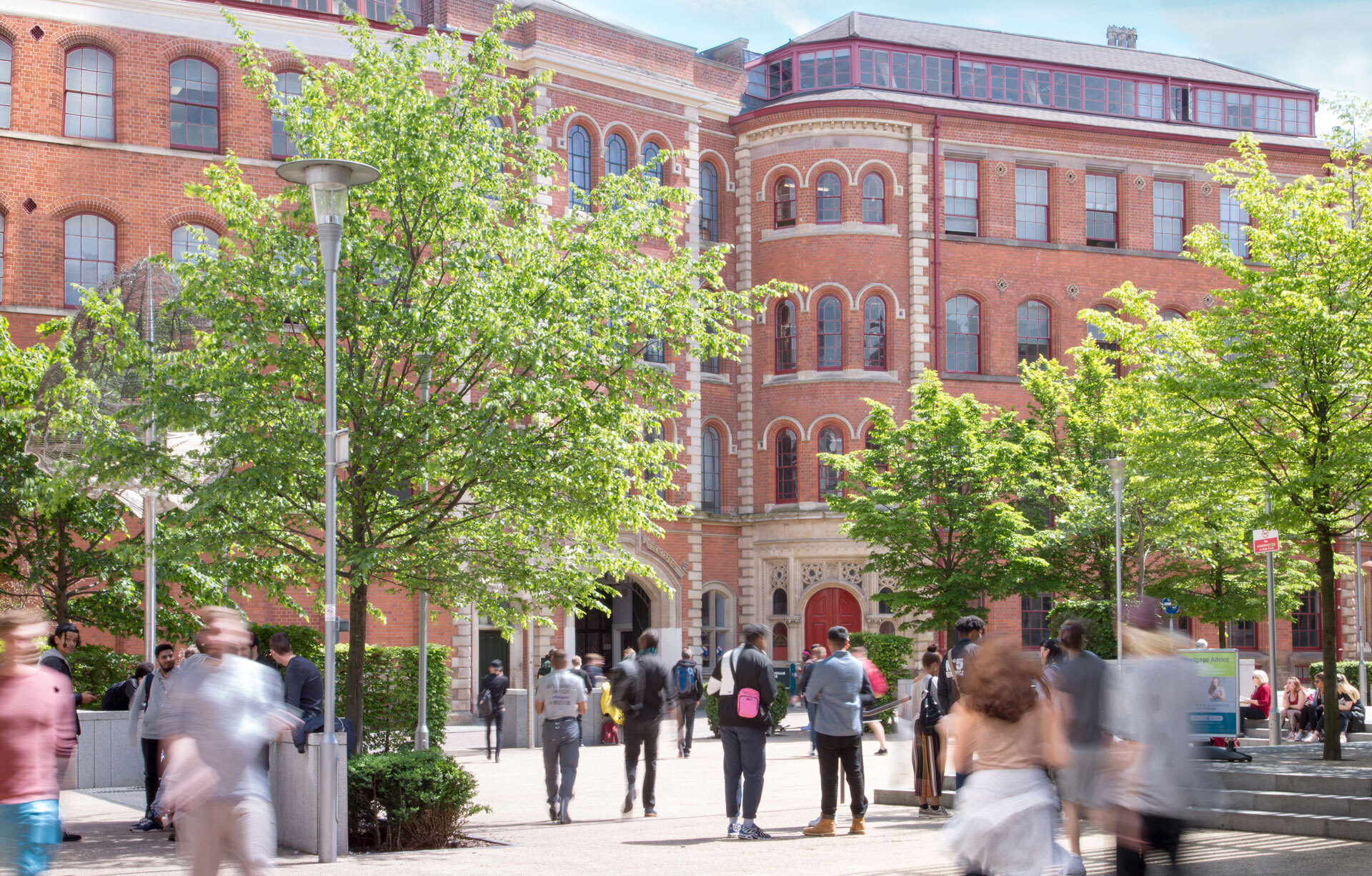 an external shot of our Adams building campus with students walking around