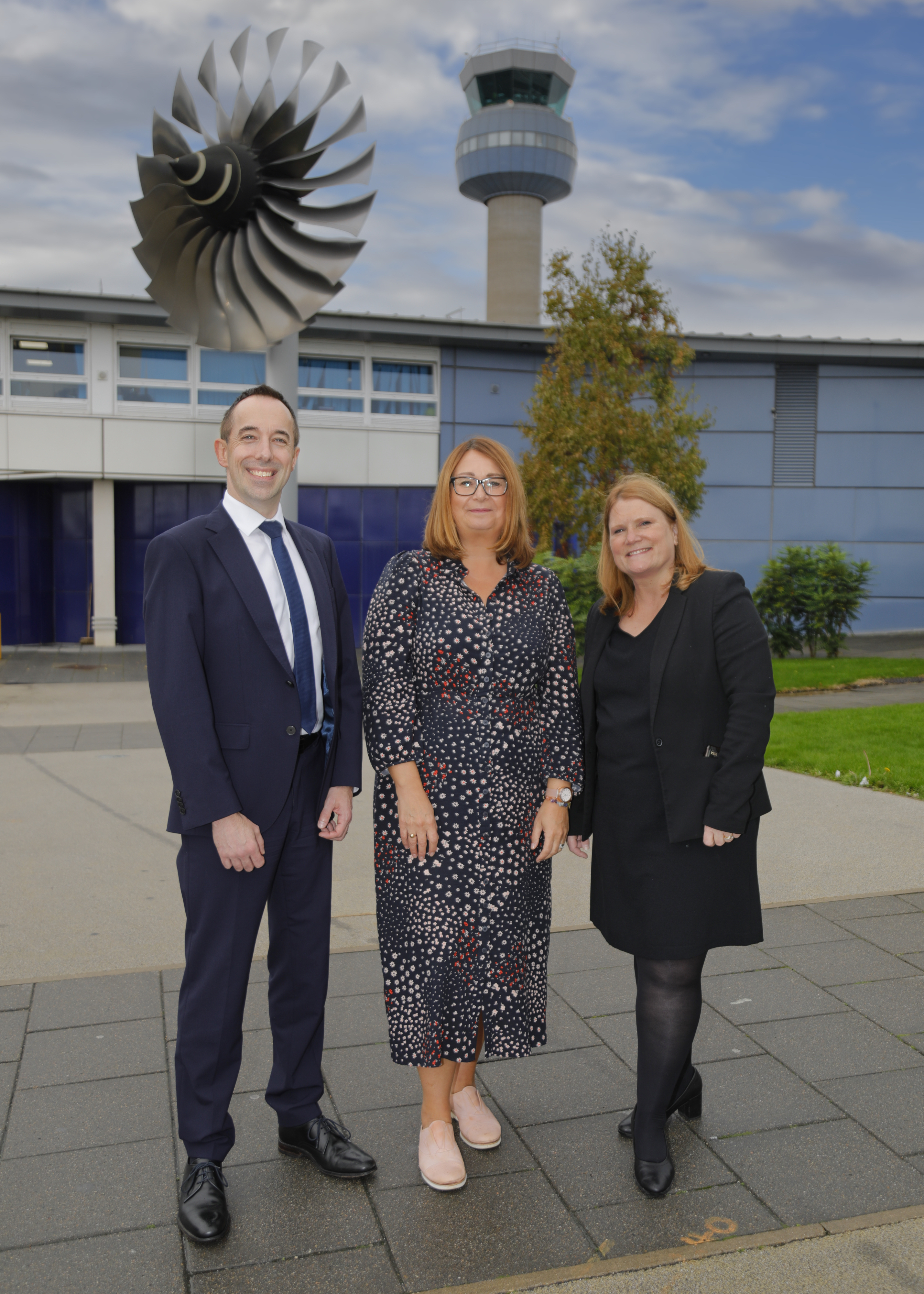 David Higham and Lisa Wilson with a representative from East Midlands Airport
